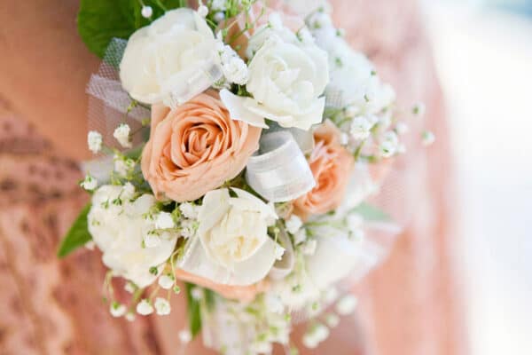 AdobeStock_216021826_WEB A bridesmaid in a textured dress with an intricate corsage.