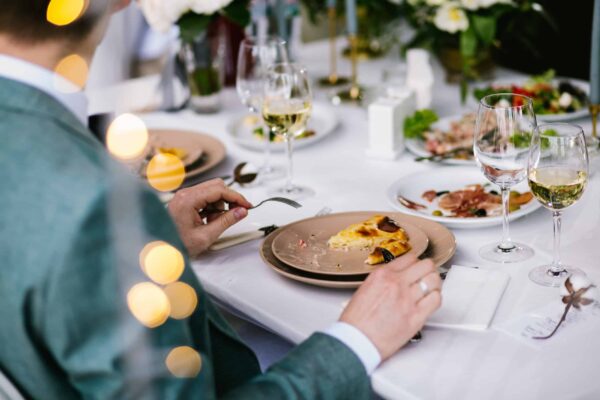 Guest eats on the event A man eating at an intricately decorated table.