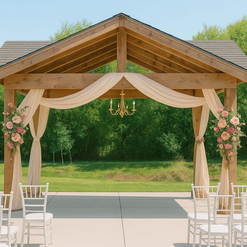 An outdoor wedding area, with a pergola and tables for guests.