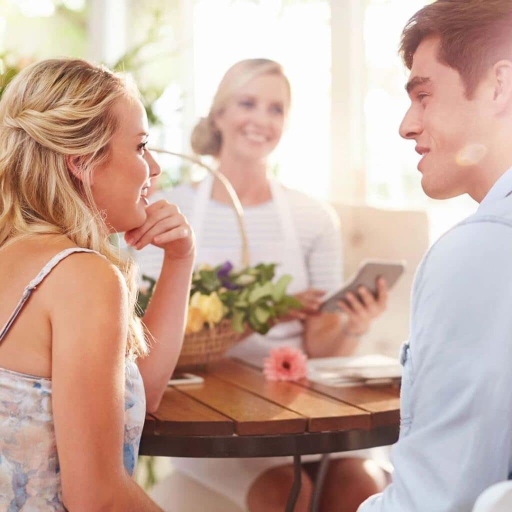 wedding planner, couple talking in foreground